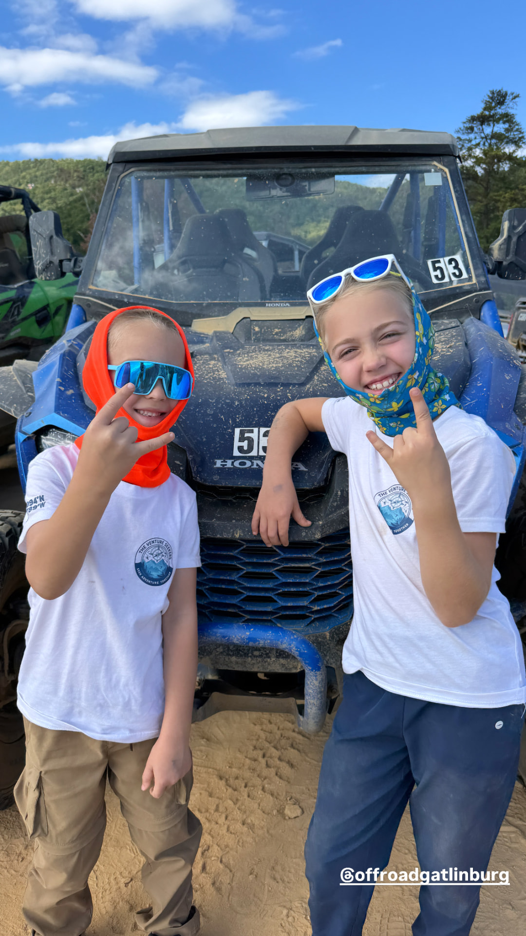 Our kids posing in front of a mud covered UTV at Off-Road Gatlinburg