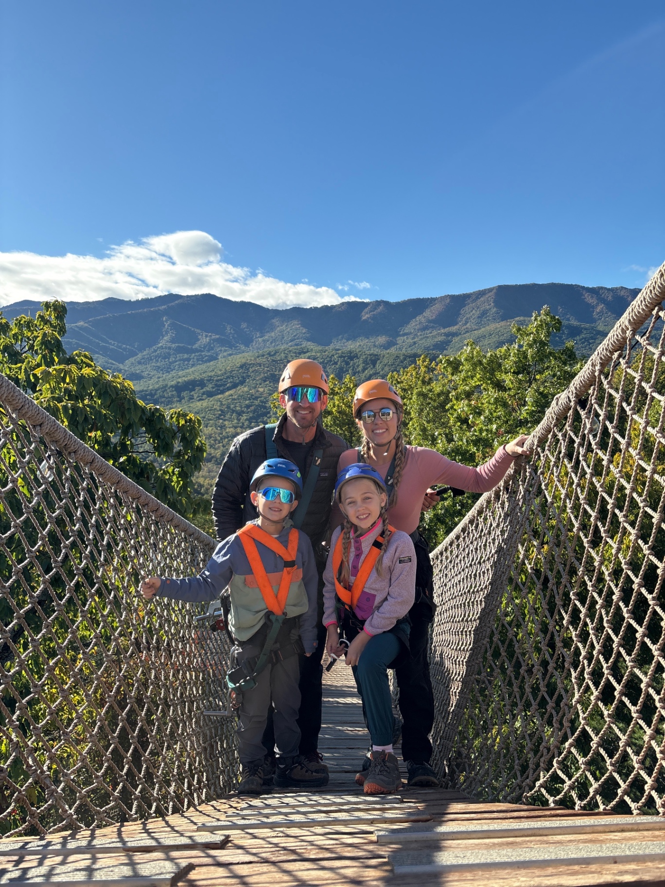 The whole family on a skybridge with the Great Smoky Mountains in the background
