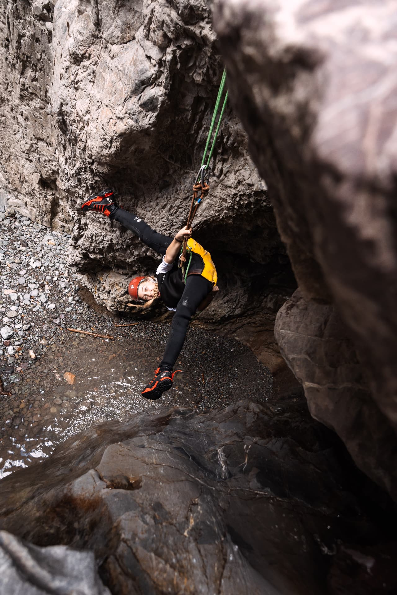 Rappelling down into the water at the bottom of Portland Creek canyon