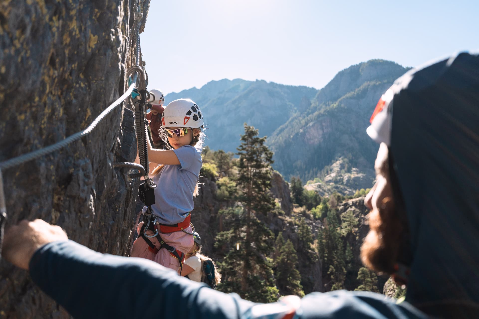 Our daughter clipping into the steel cable on the Ouray Via Ferrata with the gorge behind her