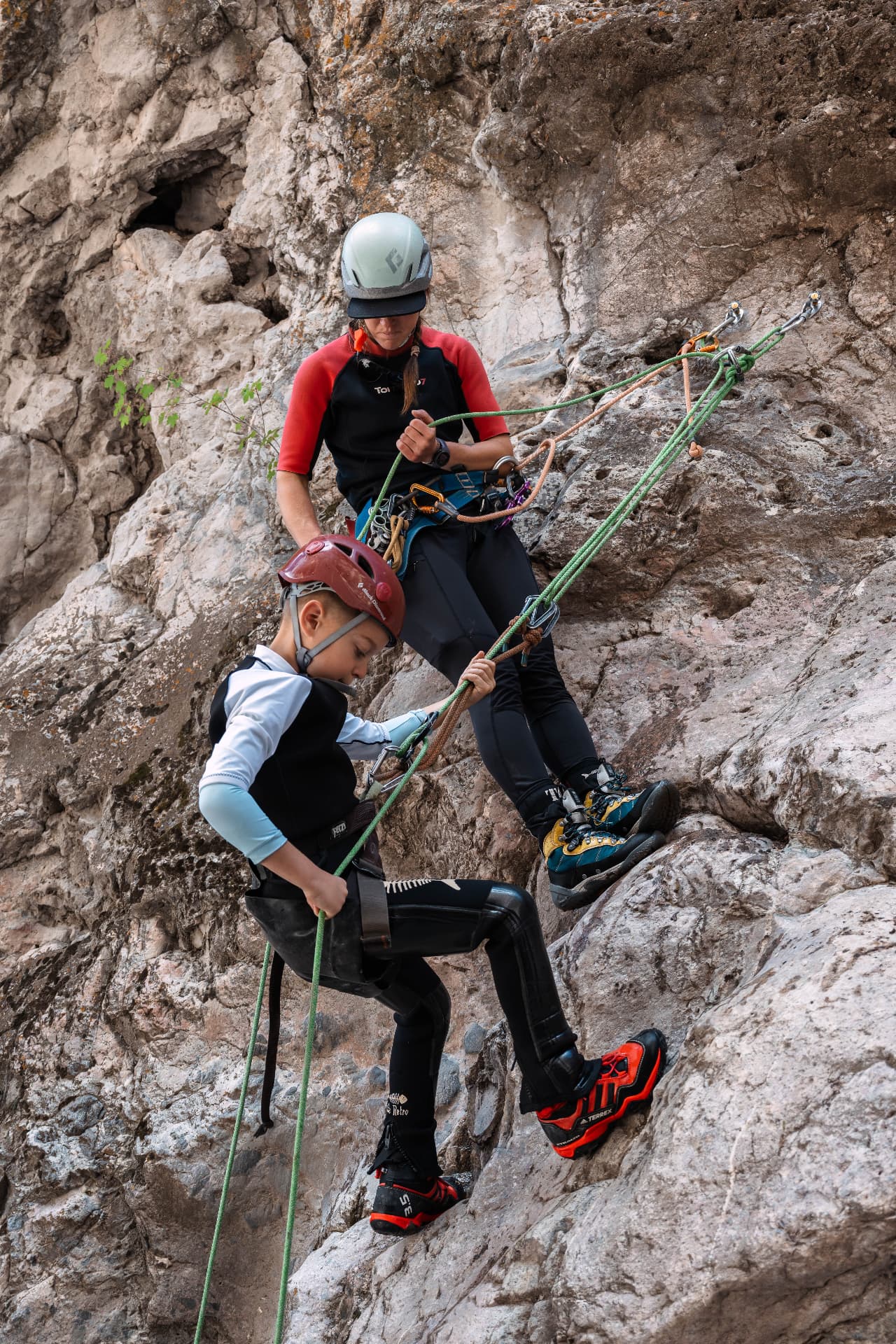 A Canyoning Colorado guide walking our son through his rappel step by step