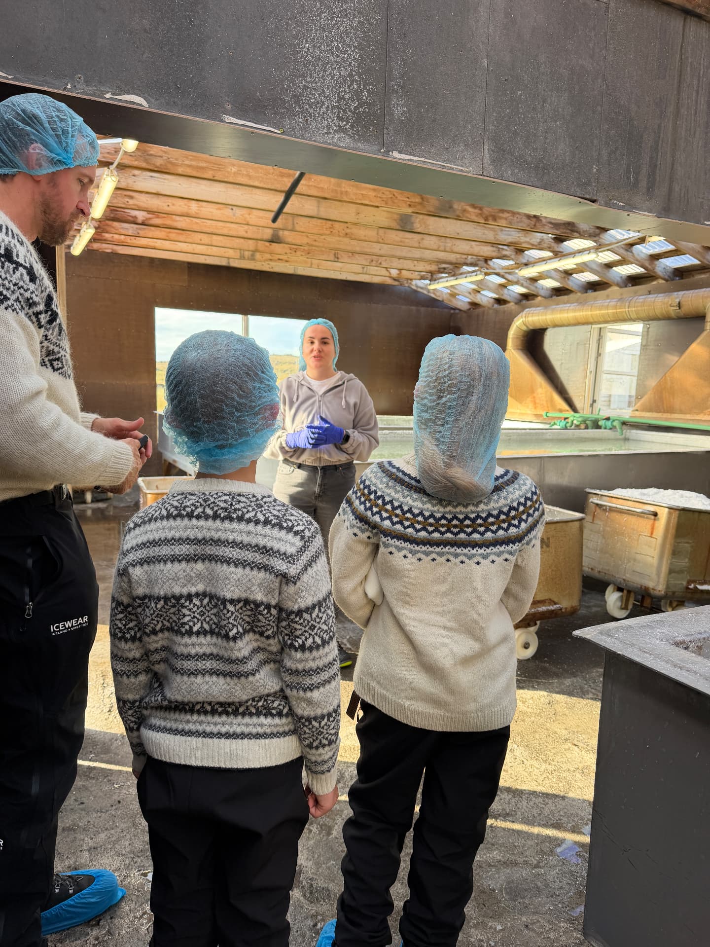 Aniston and Noah in their wool sweaters on a local factory tour, learning straight from the people who make it