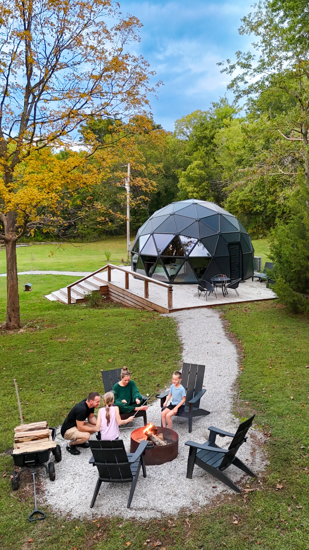 The Dome at Blueberry Hill geodesic dome with a firepit and family gathered outside