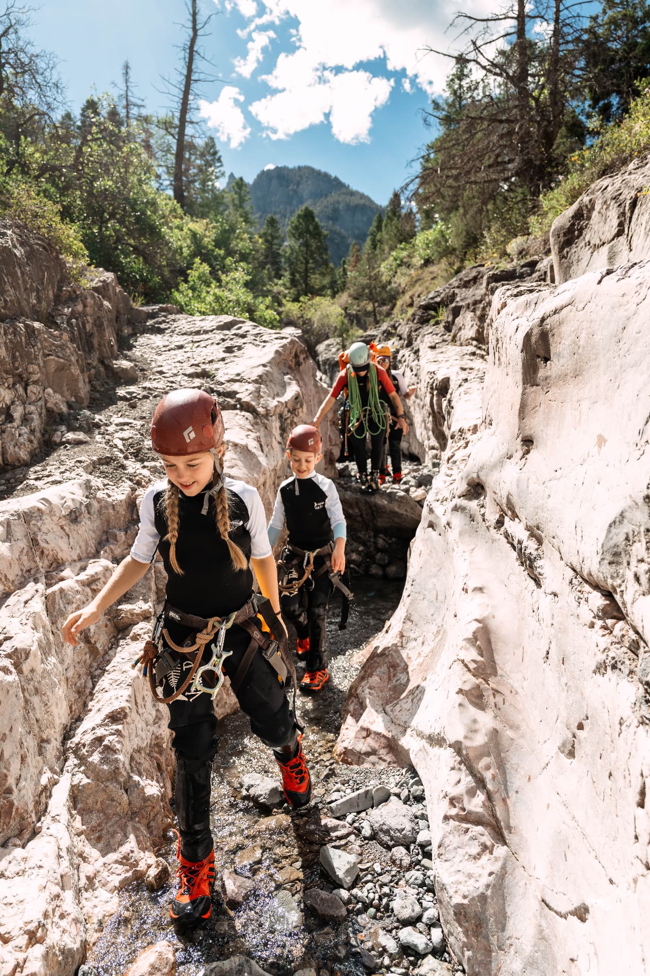 Our kids walking through the narrow limestone slot of Portland Creek canyon