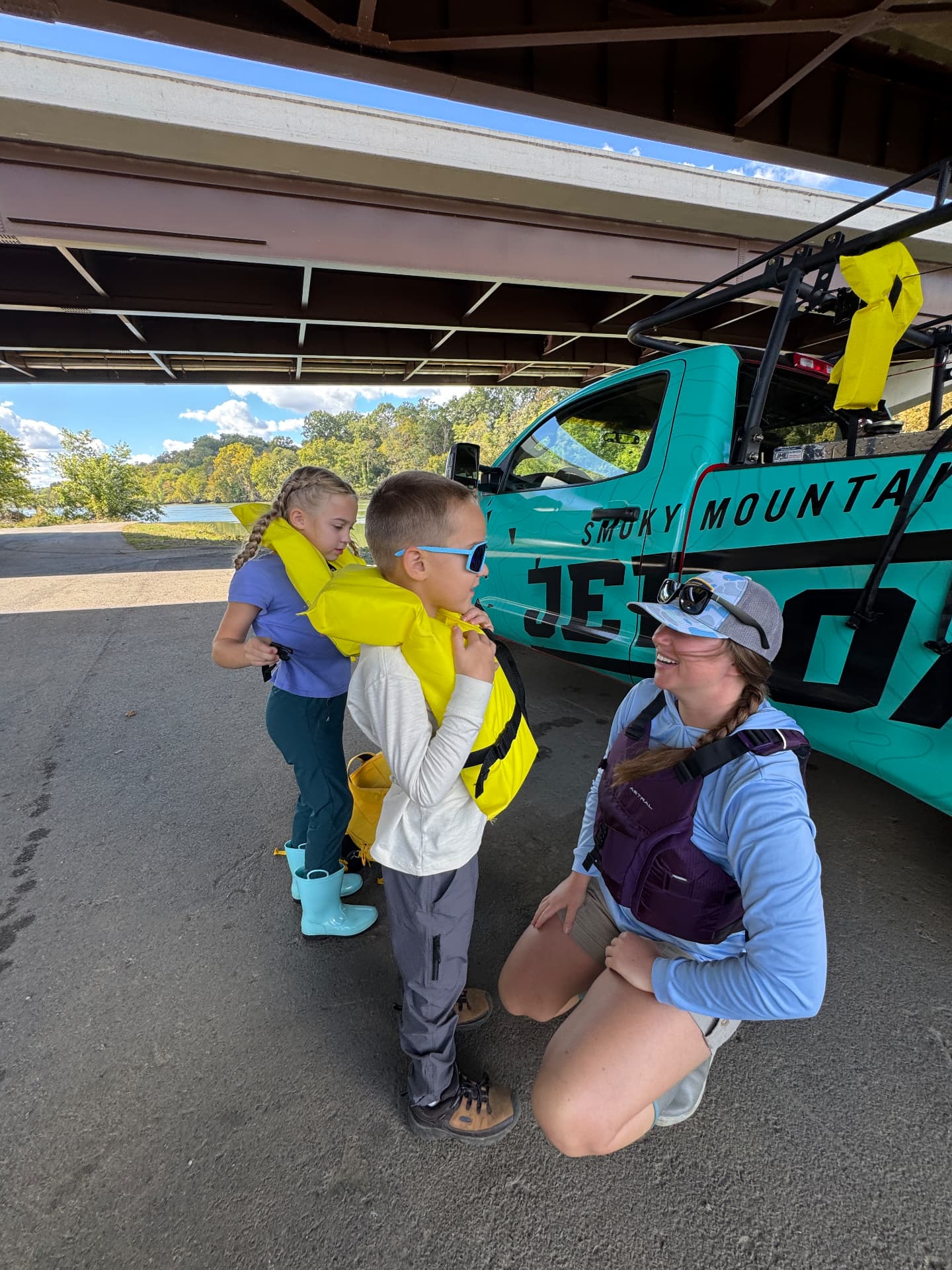 Getting our kids buckled into life jackets before the Smoky Mountain Jet Boat tour