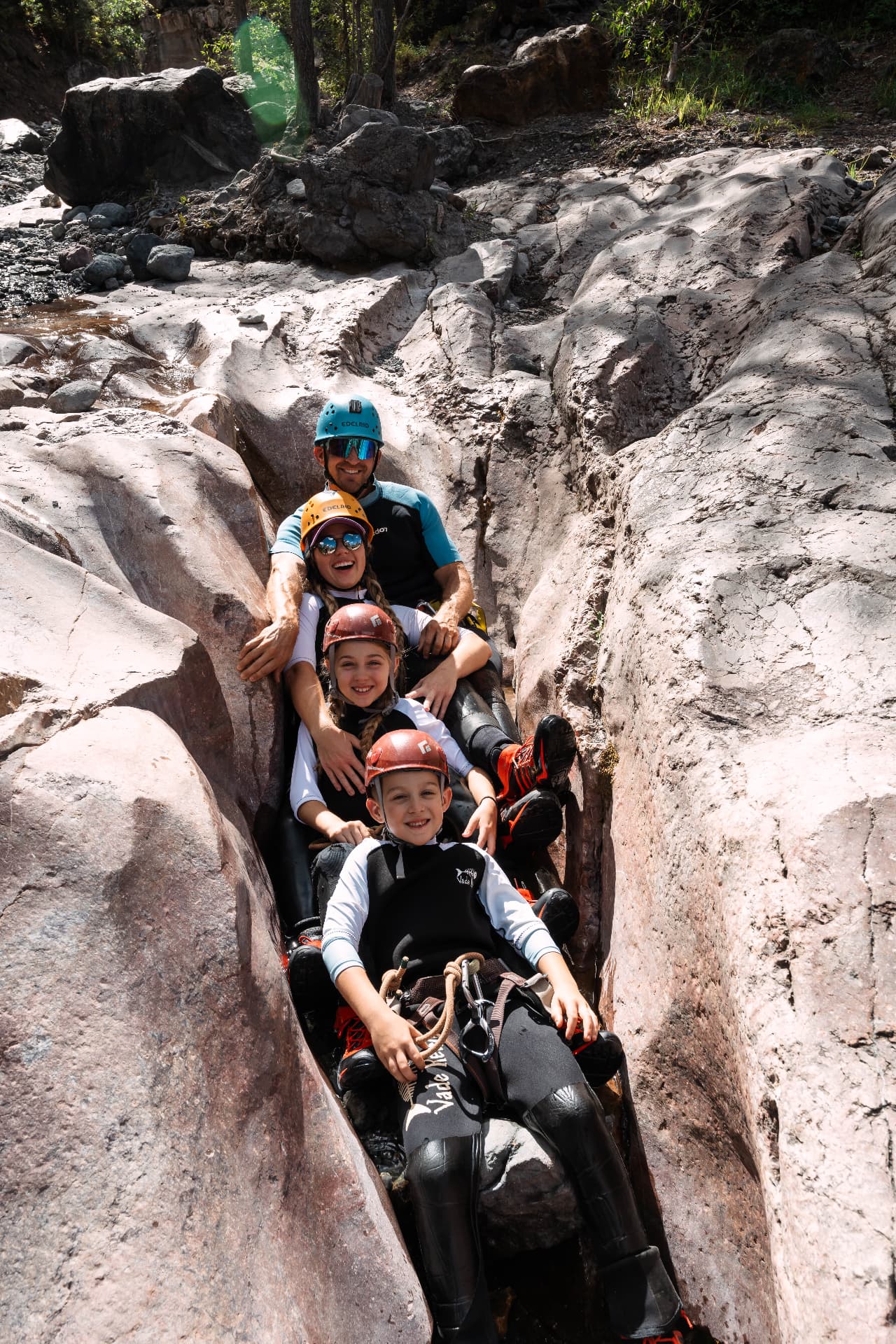 All four of us stacked in a natural rock slide inside Portland Creek canyon