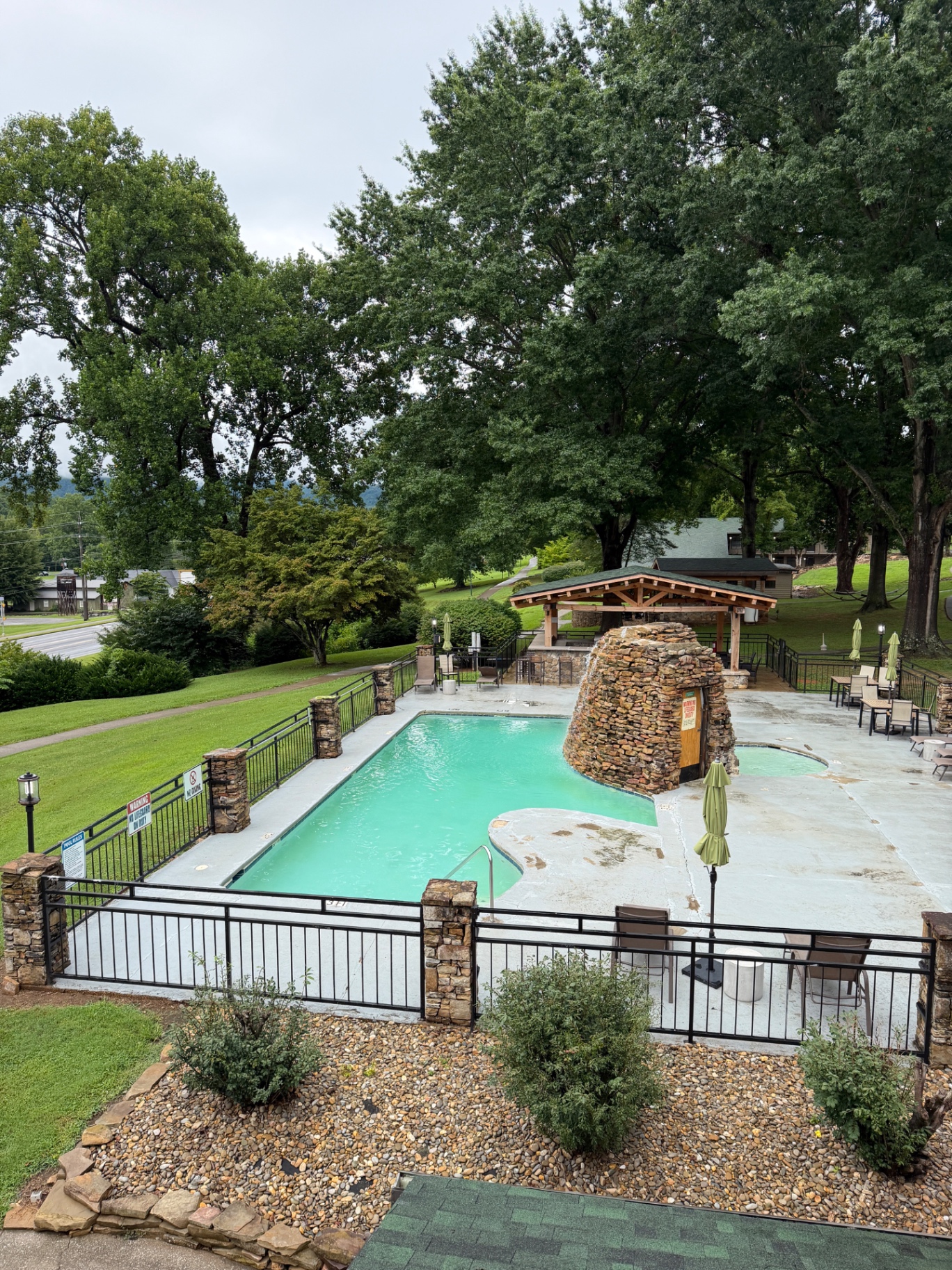Outdoor pool and hot tub at Tremont Lodge and Resort surrounded by green trees