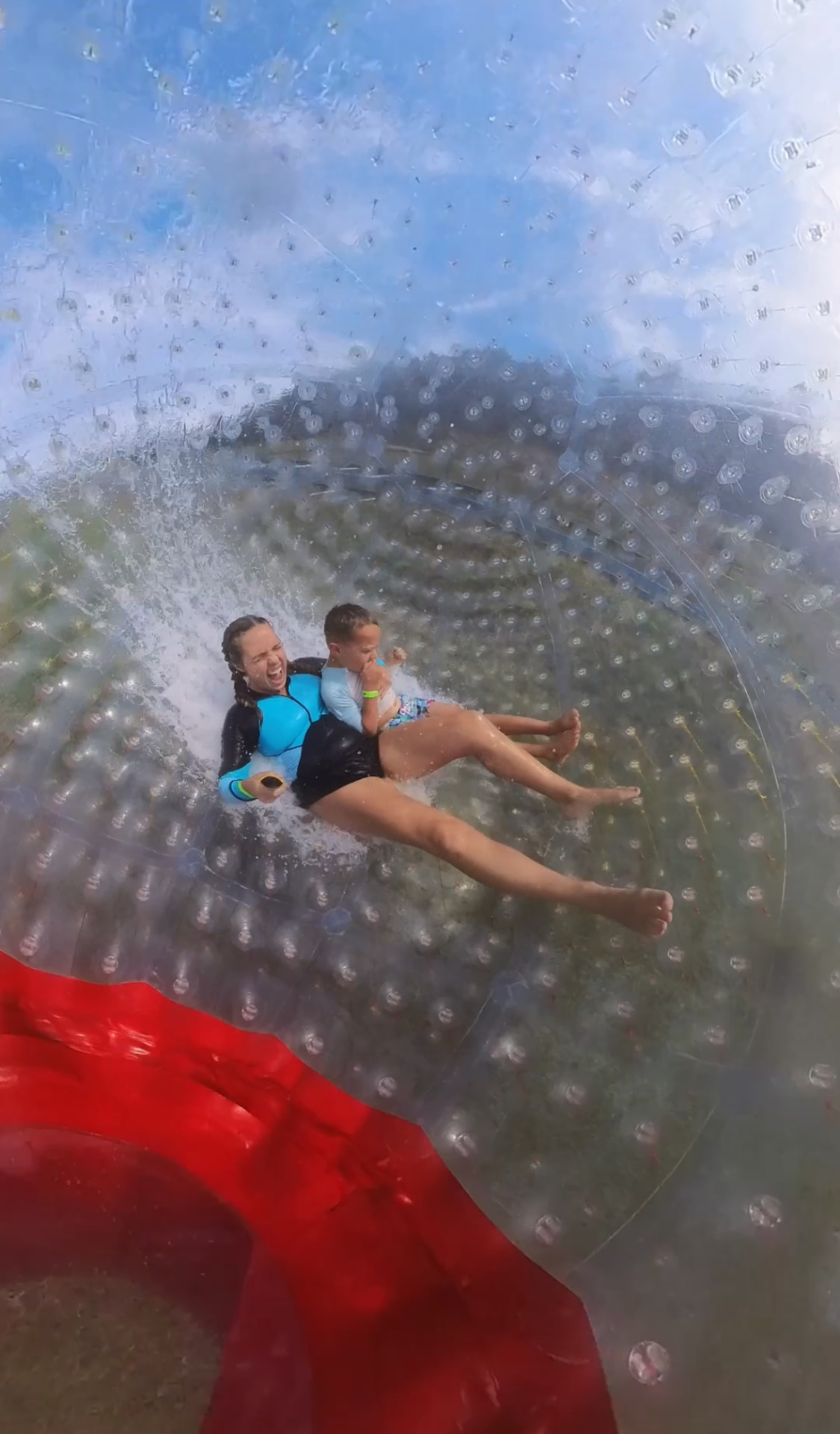 Brittany and our son mid roll inside the water zorb at Outdoor Gravity Park