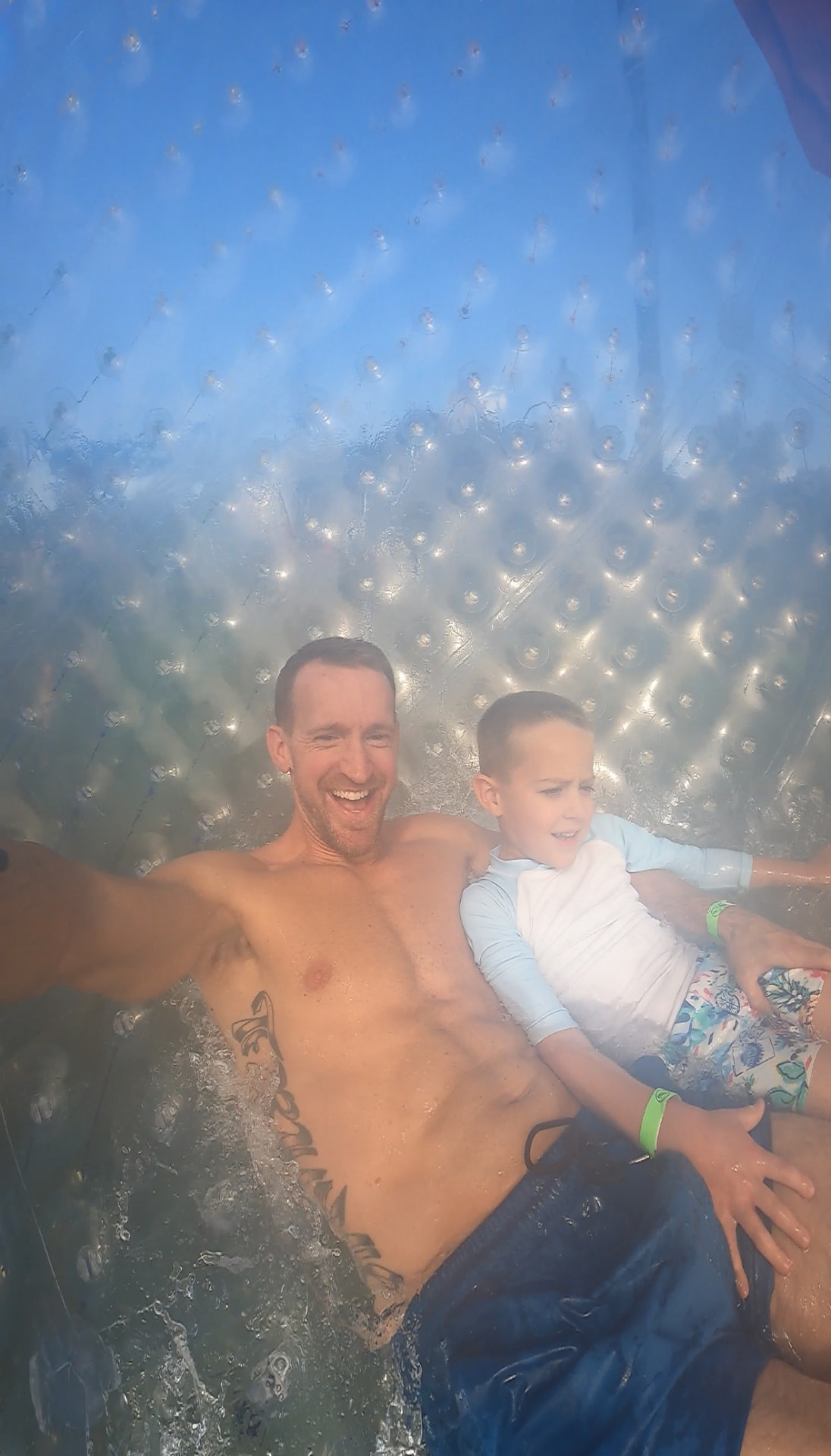 Jake and our son laughing inside the water zorb at Outdoor Gravity Park