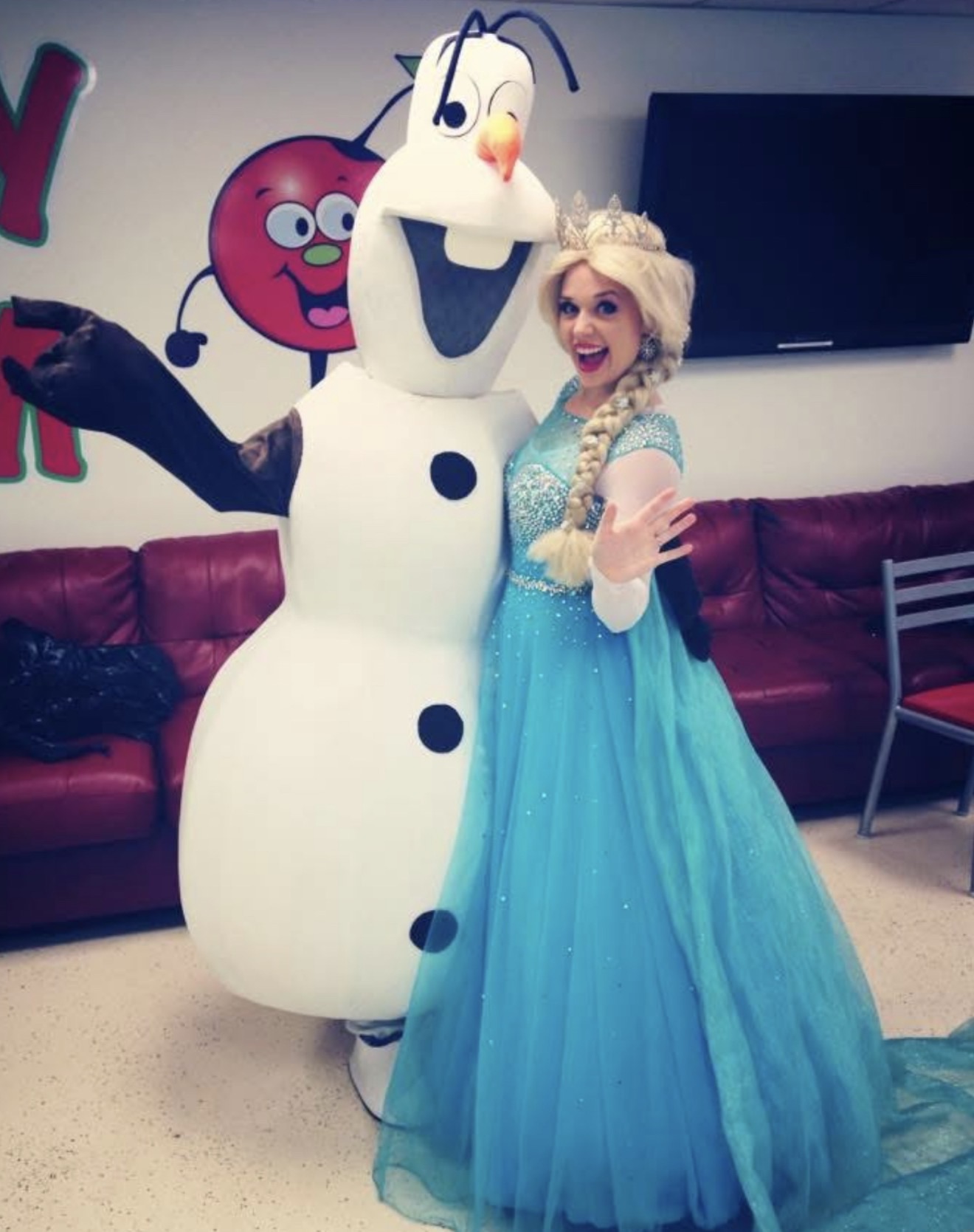 Brittany as Elsa from Frozen posing with Olaf at a character event